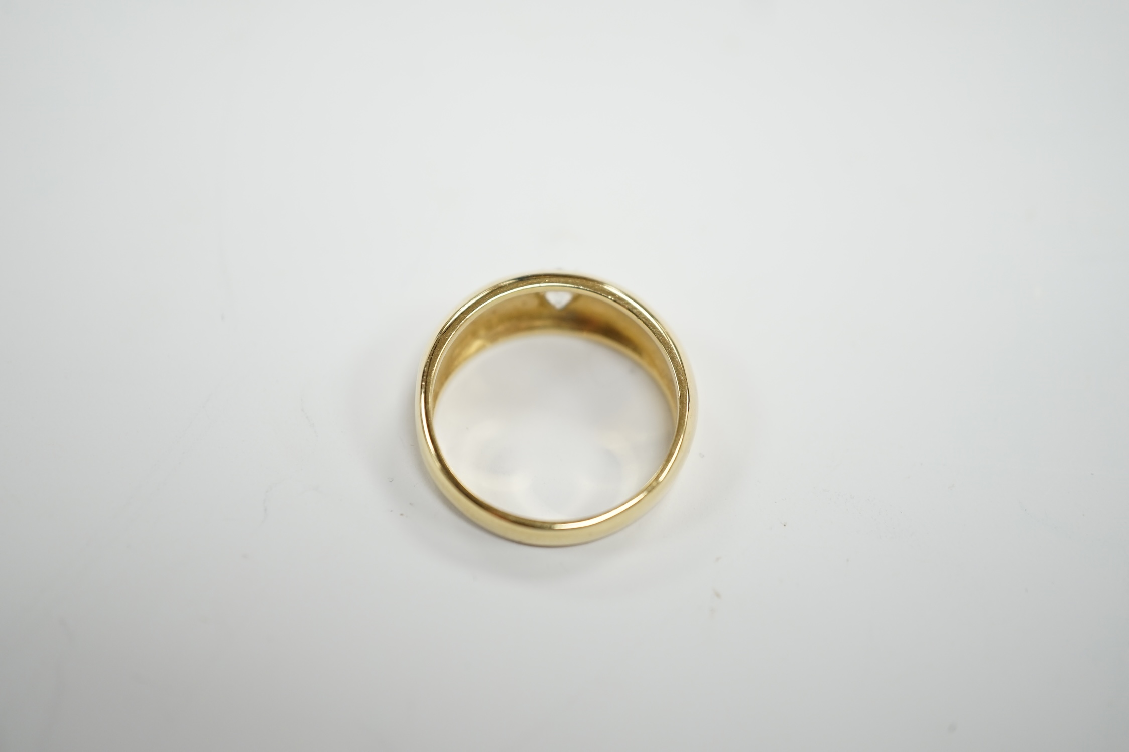 An 18ct gold and gypsy set solitaire diamond ring, size Q, gross weight 6.7 grams.